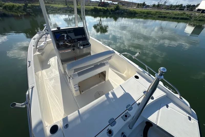 Slide: The Image of 2014 Boston Whaler 210 Dauntless boat interior with steering console on calm water. - 30