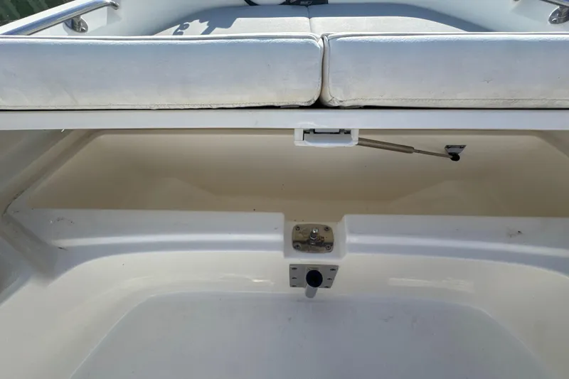 Slide: The Image of 2014 Boston Whaler 210 Dauntless boat storage compartment with cushioned seating. - 32