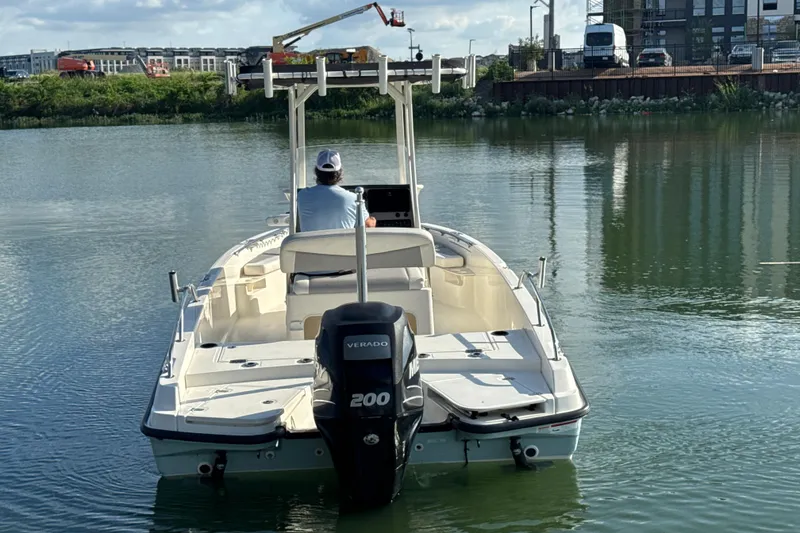 Slide: The Image of 2014 Boston Whaler 210 Dauntless boat on calm water, rear view with Verado engine. - 4