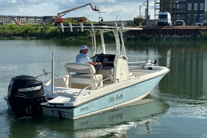 Slide: The Image of 2014 Boston Whaler 210 Dauntless boat on water, featuring Mercury engine. - 6