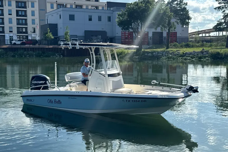 Slide: The Image of 2014 Boston Whaler 210 Dauntless boat on calm water near urban buildings. - 8