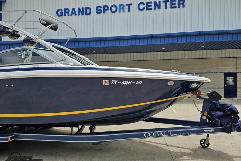 Slide: The Image of 2010 Cobalt 232 WSS boat on trailer at Grand Sport Center. - 13