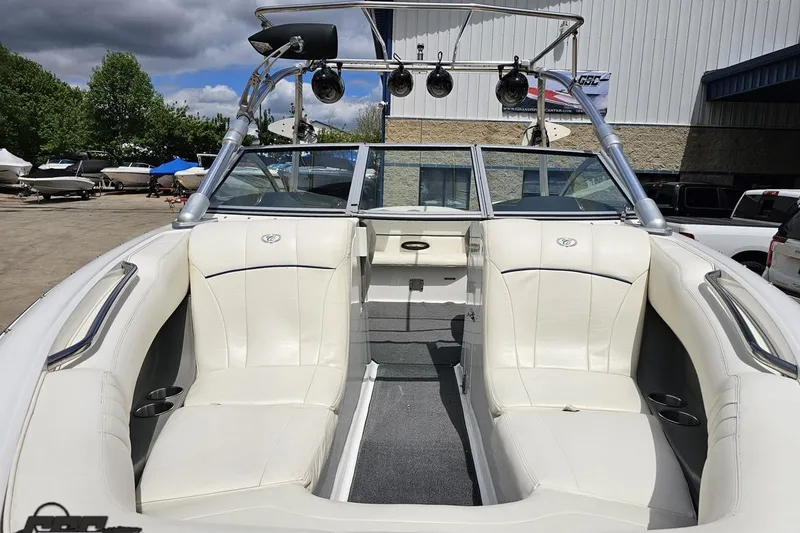 Slide: The Image of 2010 Cobalt 232 WSS boat interior with white seating and wakeboard tower. - 17