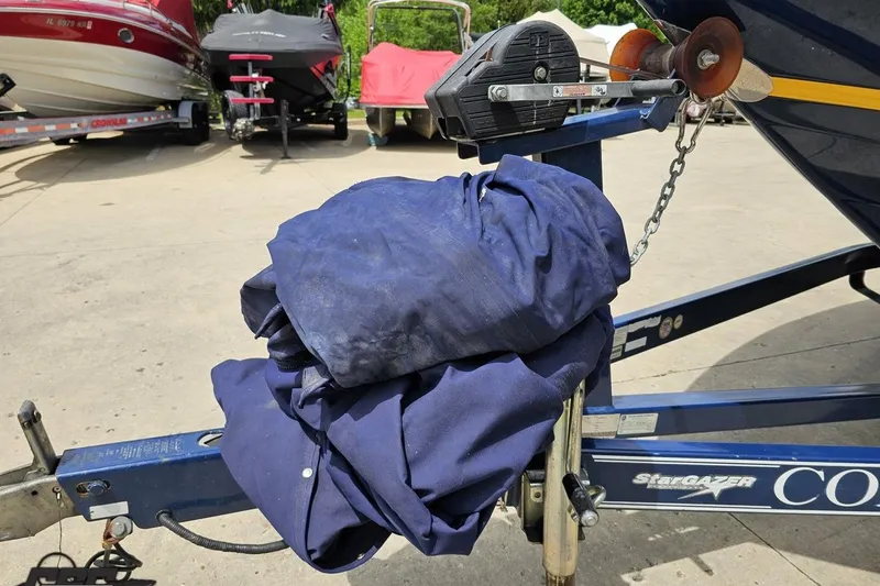 Slide: The Image of Boat trailer with blue cover, Cobalt 232 WSS, 2010 model, parked outdoors. - 19