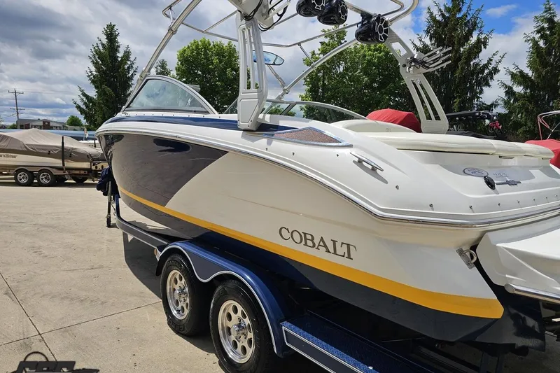 Slide: The Image of 2010 Cobalt 232 WSS boat on trailer, featuring sleek design and vibrant colors. - 29