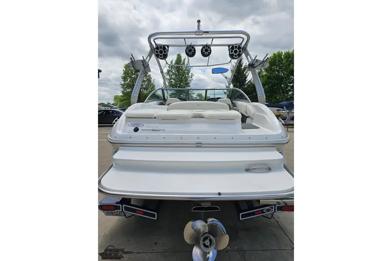 Slide: The Image of 2010 Cobalt 232 WSS boat, rear view with speakers and seating, parked outdoors. - 31