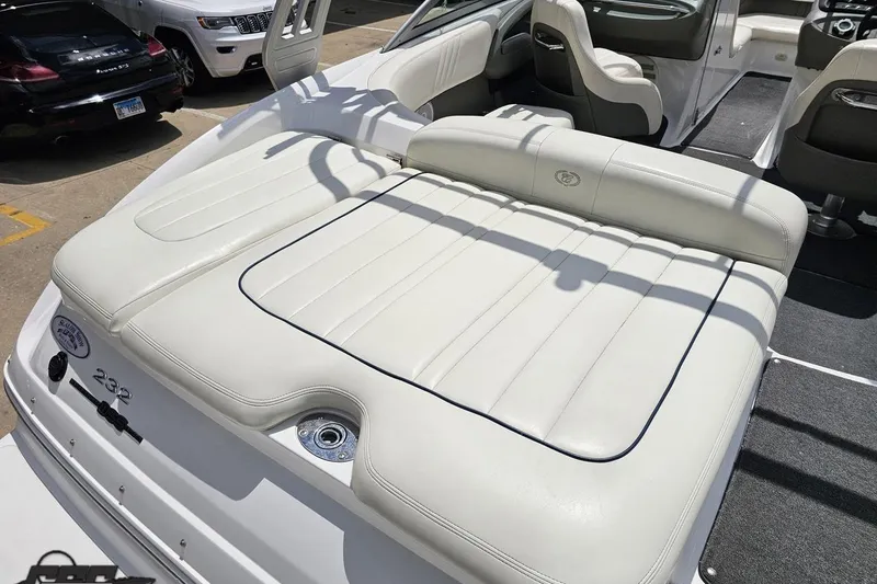 Slide: The Image of 2010 Cobalt 232 WSS boat with white leather seating and sleek interior design. - 36