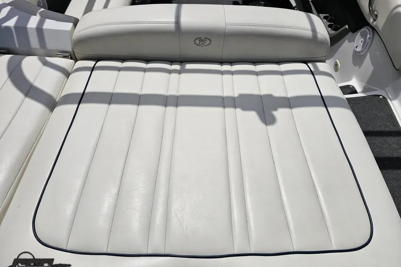 Slide: The Image of White leather seating on a 2010 Cobalt 232 WSS boat, featuring sleek stitching. - 40