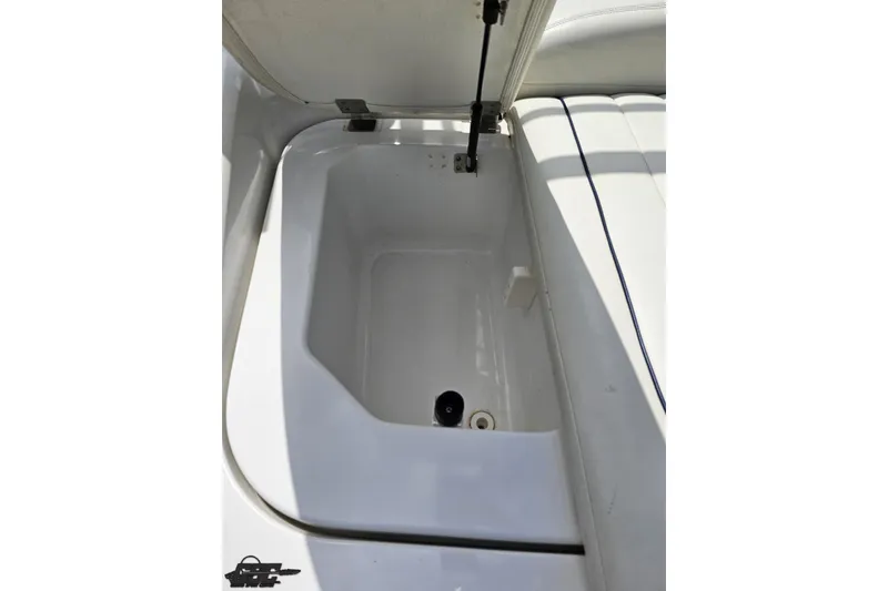 Slide: The Image of Open storage compartment in 2010 Cobalt 232 WSS boat, featuring white interior. - 42