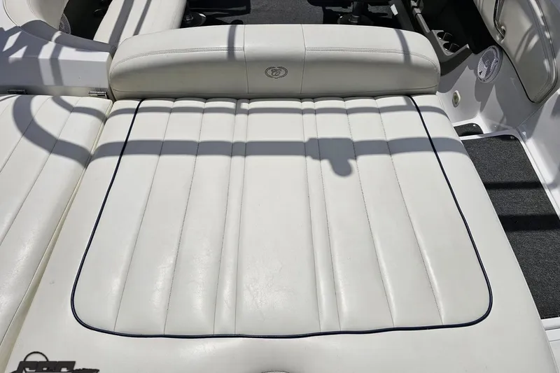 Slide: The Image of White leather seating on a 2010 Cobalt 232 WSS boat, featuring elegant stitching. - 44