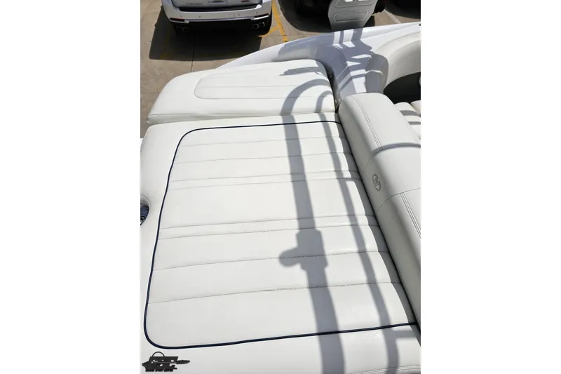 Slide: The Image of 2010 Cobalt 232 WSS boat with white leather seating and sleek design. - 46