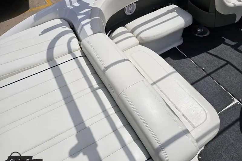 Slide: The Image of 2010 Cobalt 232 WSS boat interior with white leather seating and carpeted flooring. - 47
