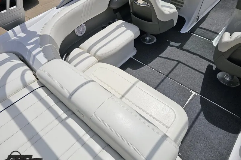 Slide: The Image of Interior of a 2010 Cobalt 232 WSS boat with white leather seating and gray carpet. - 48