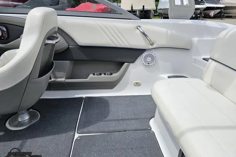 Slide: The Image of Interior of a 2010 Cobalt 232 WSS boat with white seating and carpeted flooring. - 50