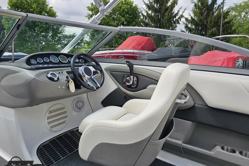 Slide: The Image of Interior of a 2010 Cobalt 232 WSS boat, featuring a sleek dashboard and comfortable seating. - 51