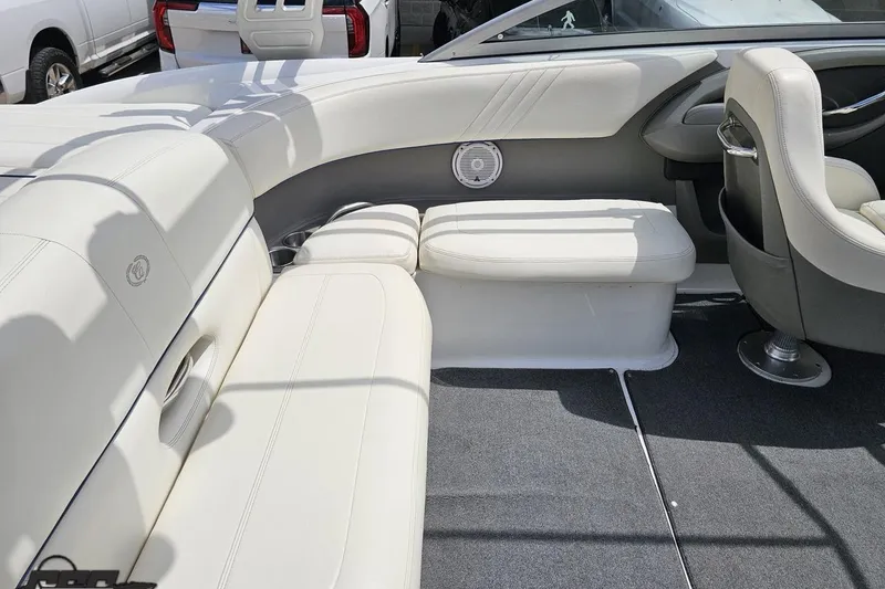 Slide: The Image of Interior of a 2010 Cobalt 232 WSS boat with white leather seating and speaker. - 52