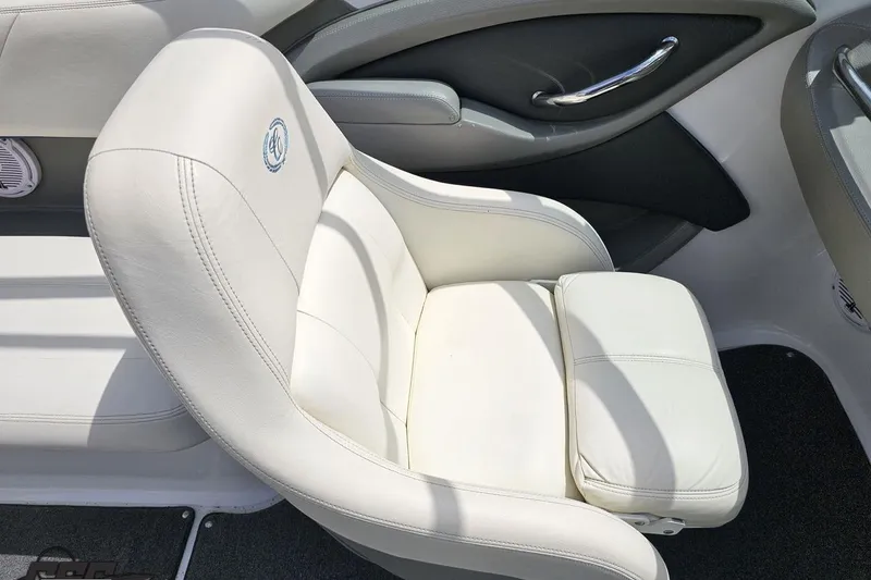 Slide: The Image of White leather seat in a 2010 Cobalt 232 WSS boat, featuring sleek design and comfort. - 56