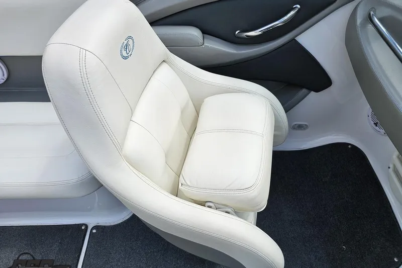Slide: The Image of White leather seat in a 2010 Cobalt 232 WSS boat interior. - 57