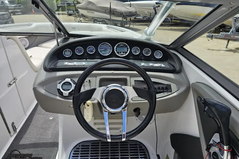 Slide: The Image of Steering console of a 2010 Cobalt 232 WSS boat with gauges and controls. - 64