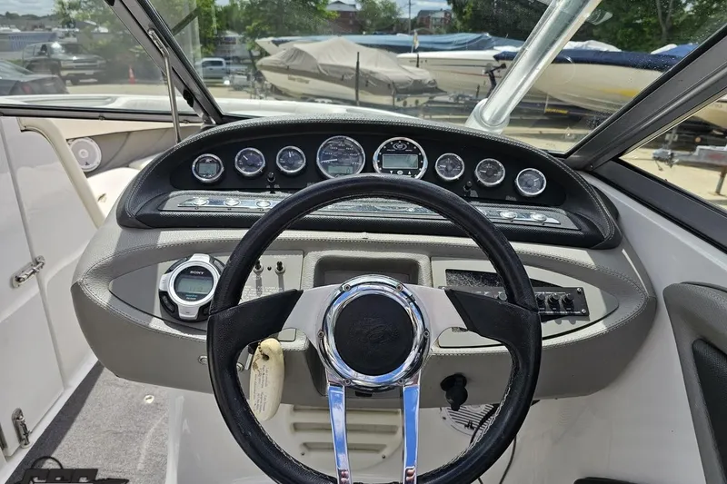 Slide: The Image of Steering console of a 2010 Cobalt 232 WSS boat with gauges and controls. - 65