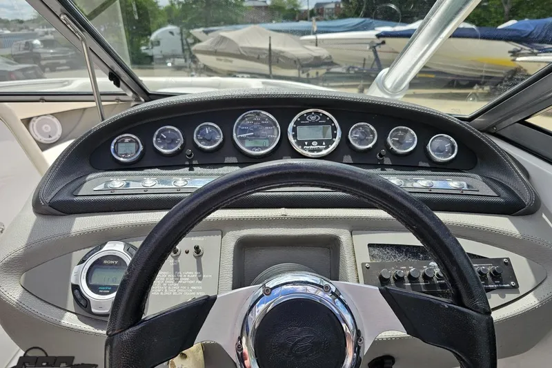 Slide: The Image of Dashboard of a 2010 Cobalt 232 WSS boat with gauges and steering wheel. - 66