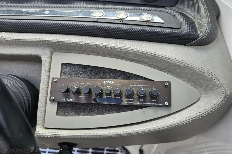 Slide: The Image of 2010 Cobalt 232 WSS boat dashboard with WS-420BT equalizer and control buttons. - 67