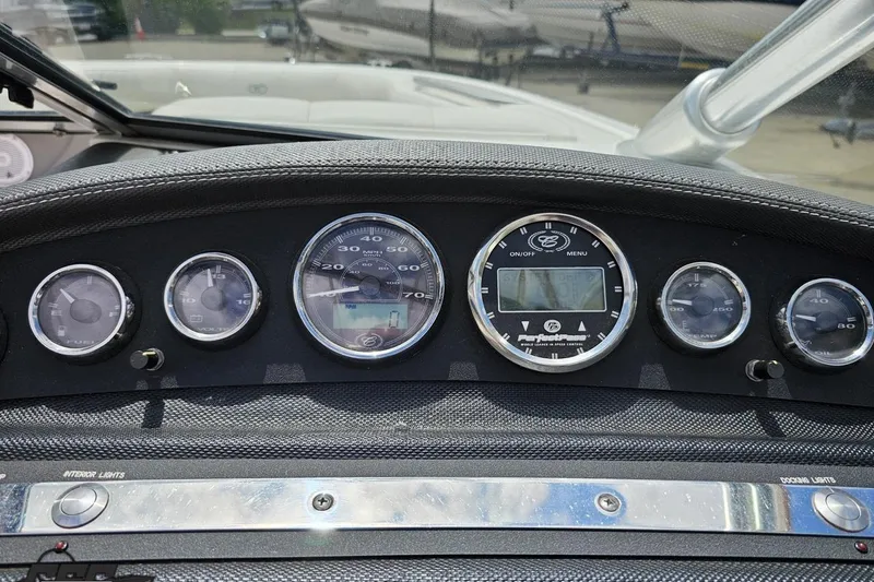 Slide: The Image of Dashboard of a 2010 Cobalt 232 WSS boat with various gauges and controls. - 68