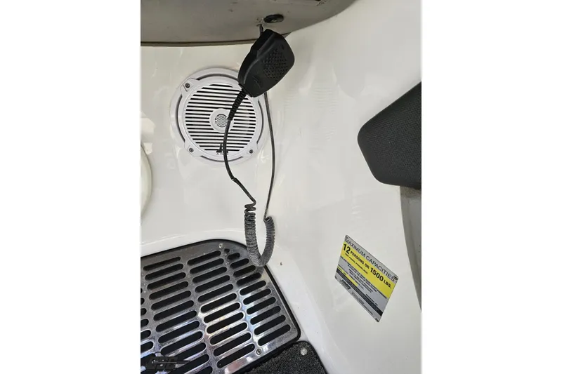 Slide: The Image of Interior of 2010 Cobalt 232 WSS boat with speaker, microphone, and capacity label. - 69