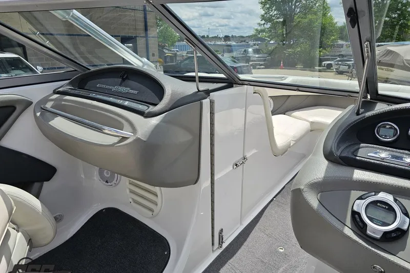 Slide: The Image of Interior of a 2010 Cobalt 232 WSS boat, featuring sleek dashboard and seating. - 70