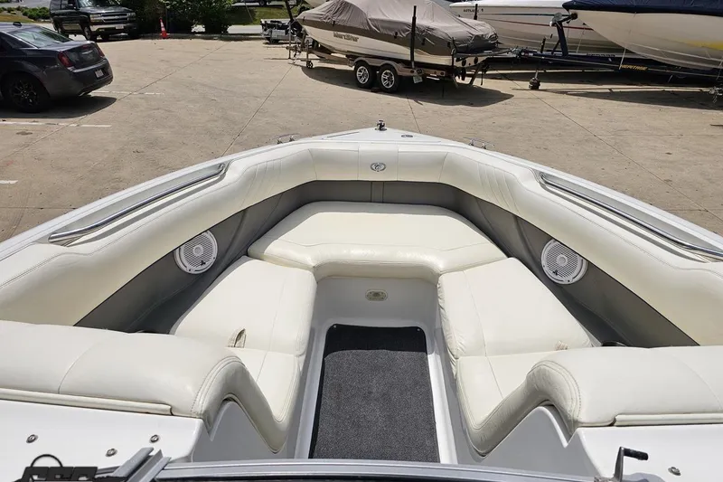 Slide: The Image of 2010 Cobalt 232 WSS boat interior with white seating and speakers. - 71