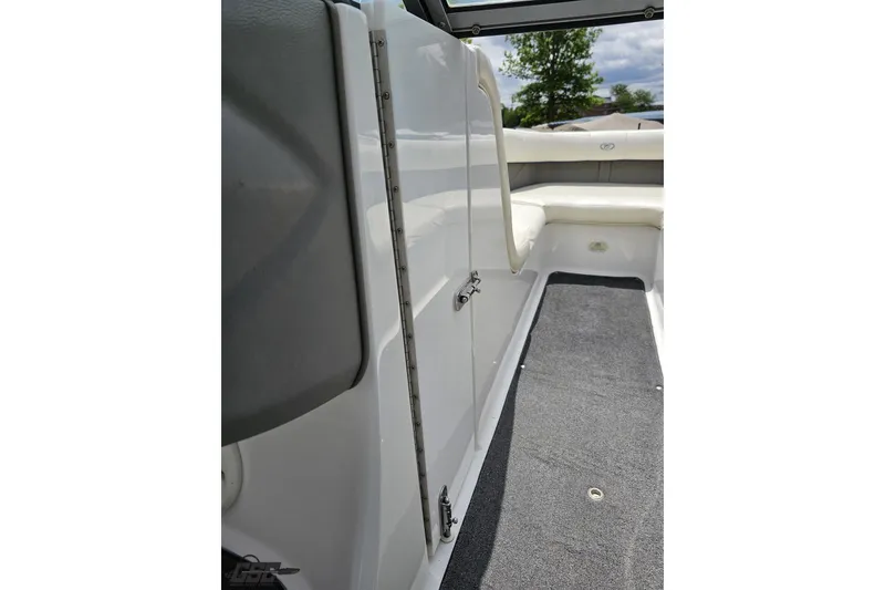 Slide: The Image of 2010 Cobalt 232 WSS boat interior with white seating and gray carpet. - 72