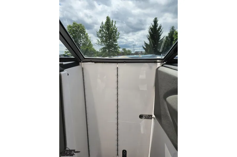 Slide: The Image of Interior view of a 2010 Cobalt 232 WSS boat with closed cabin door. - 73