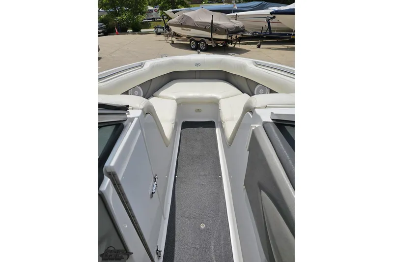 Slide: The Image of 2010 Cobalt 232 WSS boat interior with cushioned seating and carpeted floor. - 74