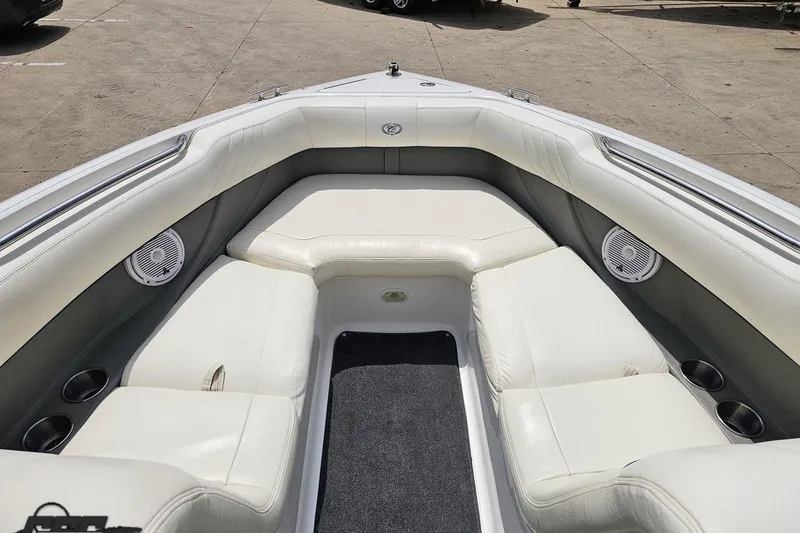 Slide: The Image of 2010 Cobalt 232 WSS boat interior with white leather seating and built-in speakers. - 75
