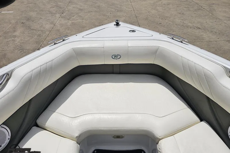Slide: The Image of 2010 Cobalt 232 WSS boat interior with white cushioned seating and sleek design. - 76