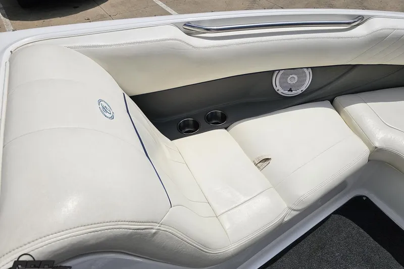 Slide: The Image of 2010 Cobalt 232 WSS boat interior with white leather seating and speaker. - 77