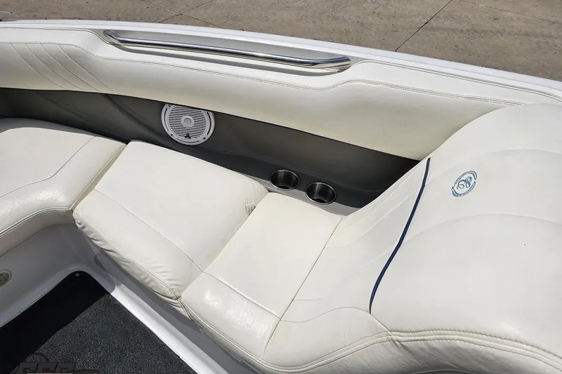 Slide: The Image of Interior of 2010 Cobalt 232 WSS boat with white leather seating and speaker. - 79