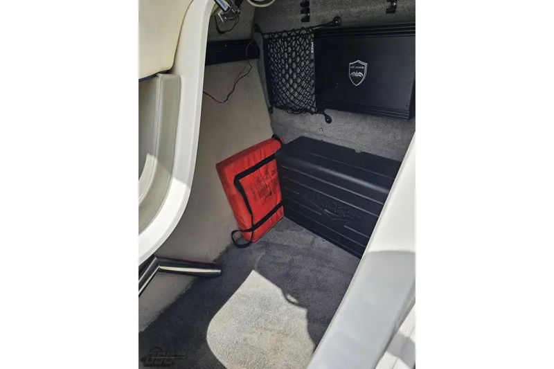 Slide: The Image of Interior of a 2010 Cobalt 232 WSS boat with storage compartment and safety equipment. - 80