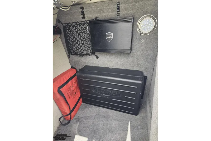 Slide: The Image of Interior of 2010 Cobalt 232 WSS boat with audio equipment and safety gear. - 81