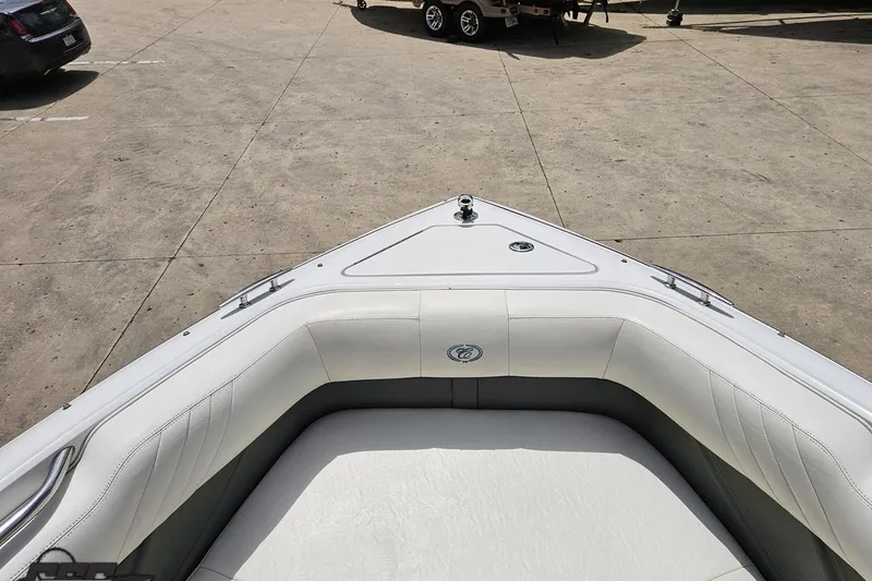 Slide: The Image of Bow seating area of a 2010 Cobalt 232 WSS boat in a parking lot. - 84