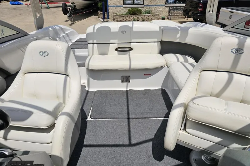 Slide: The Image of 2010 Cobalt 232 WSS boat interior with white seating and gray carpet. - 87