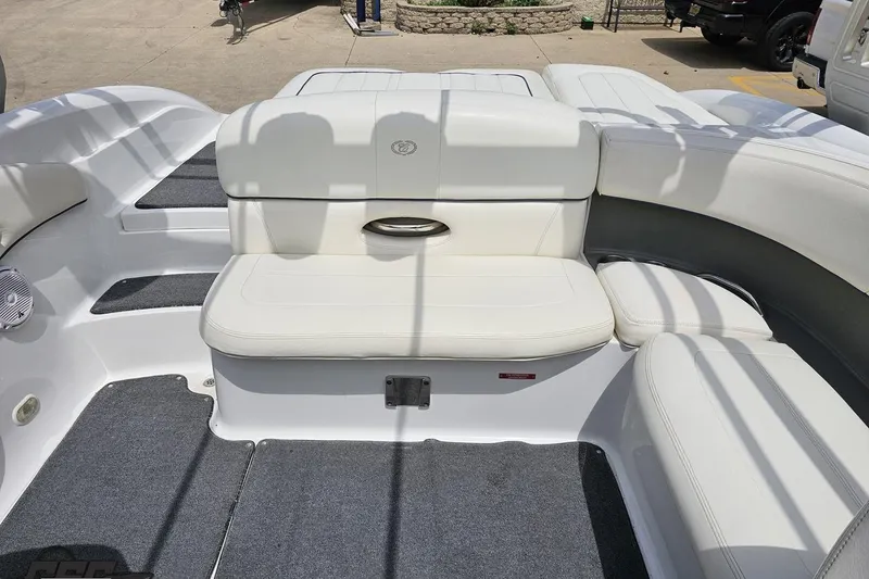 Slide: The Image of 2010 Cobalt 232 WSS boat interior with white seating and gray carpet. - 88