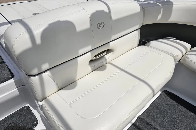 Slide: The Image of White leather seating on a 2010 Cobalt 232 WSS boat, showcasing luxury and comfort. - 91