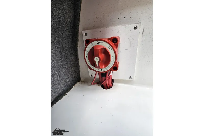 Slide: The Image of Battery switch in a 2010 Cobalt 232 WSS boat, mounted on a white panel. - 93