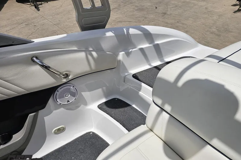Slide: The Image of Interior of a 2010 Cobalt 232 WSS boat, featuring white seating and speaker. - 94
