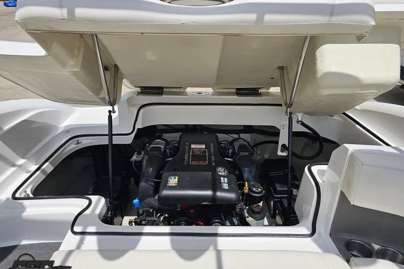 Slide: The Image of Open engine compartment of a 2010 Cobalt 232 WSS boat, showcasing the engine details. - 97