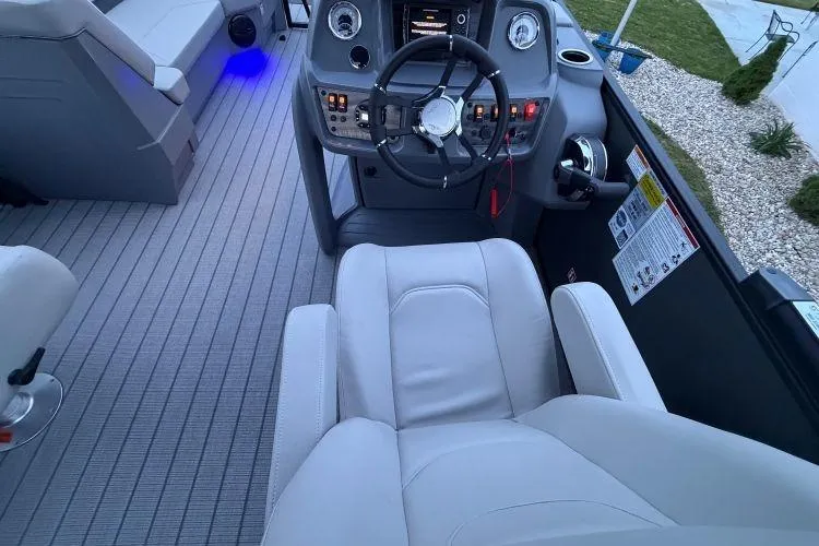 Slide: The Image of 2026 SunChaser Lucerne 22 LR DH Sport boat interior with modern helm and seating. - 7