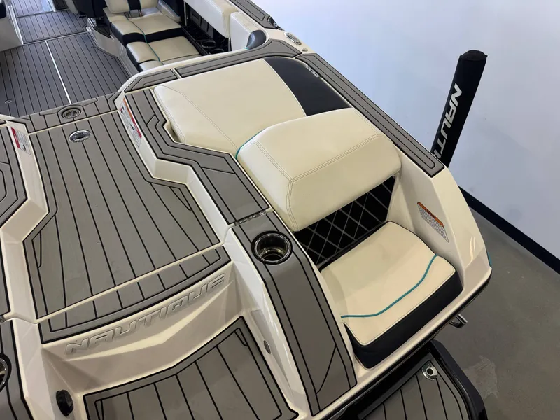 Slide: The Image of 2020 Nautique Super Air Nautique GS24 interior with gray and white seating. - 11