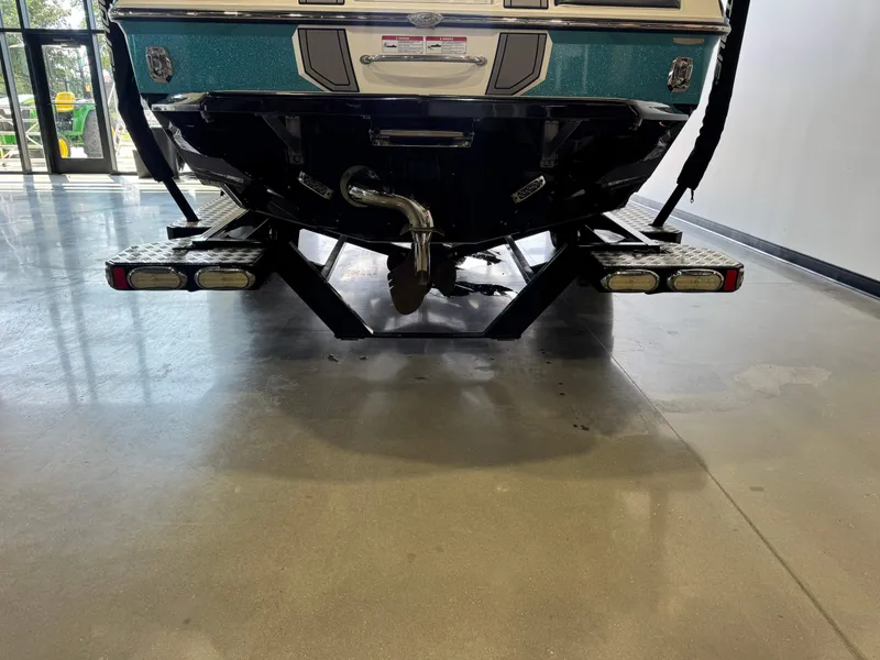 Slide: The Image of Rear view of a 2020 Nautique Super Air Nautique GS24 boat in showroom. - 7