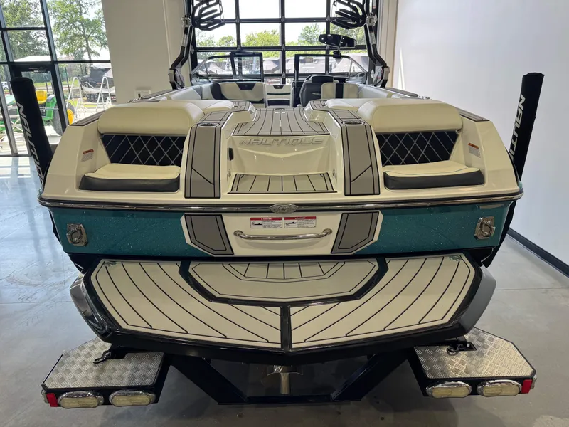 Slide: The Image of Rear view of a 2020 Nautique Super Air Nautique GS24 boat in showroom. - 8